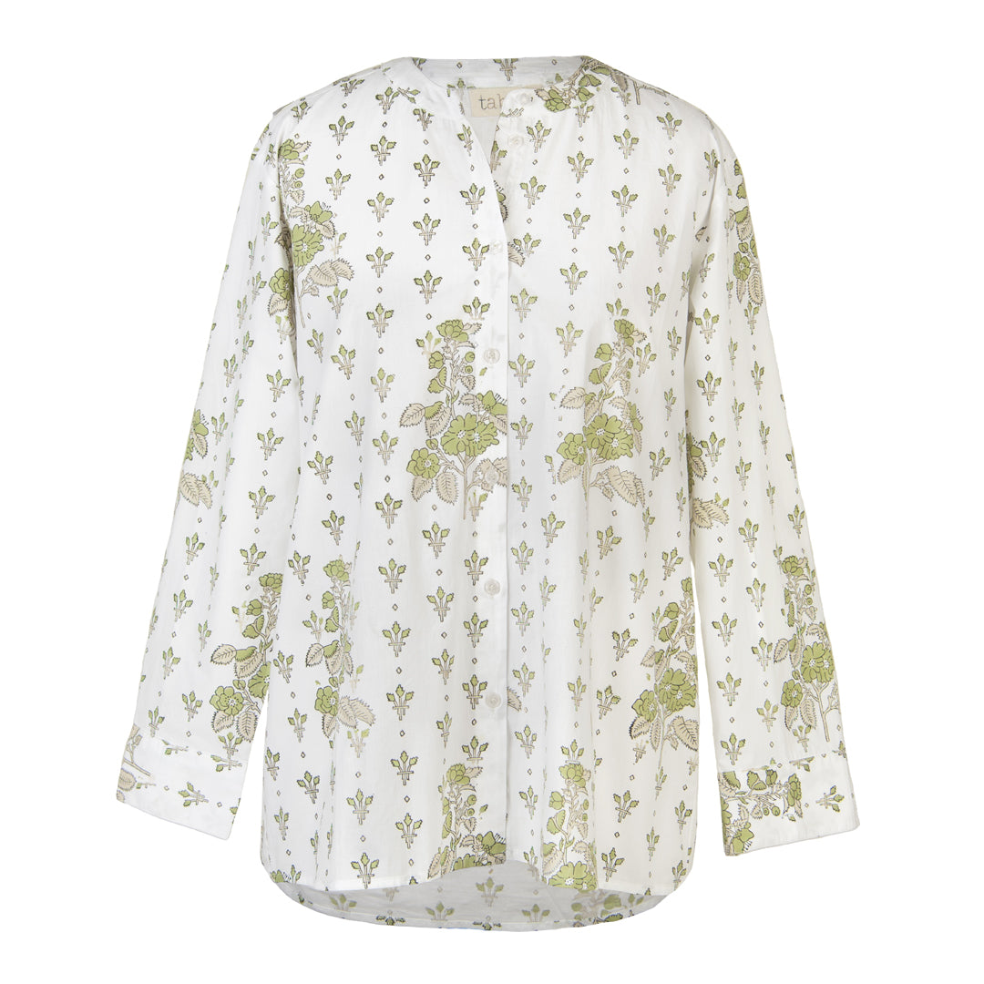 White blouse with green floral pattern on a white background