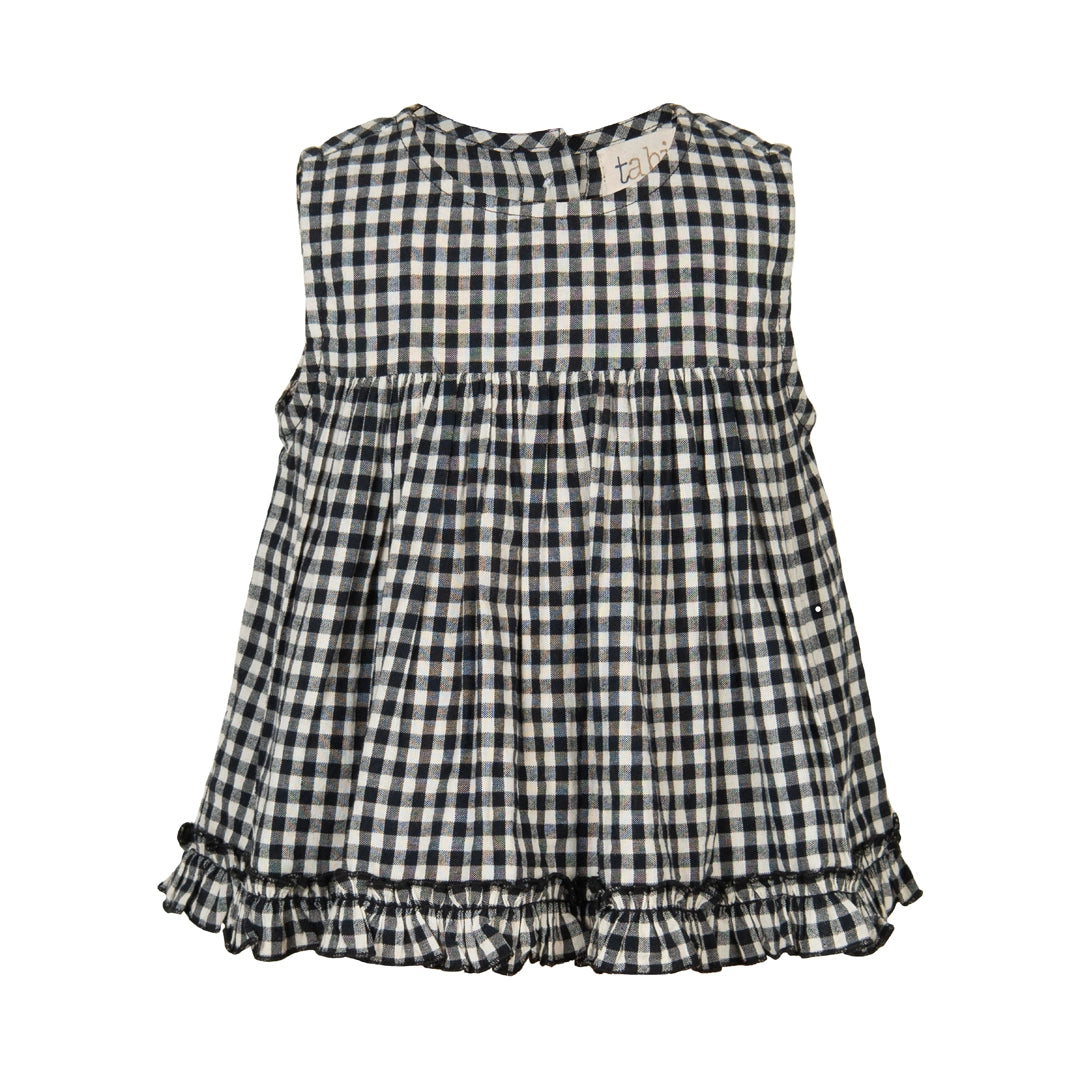 Black and white checkered dress with ruffled hem on a white background