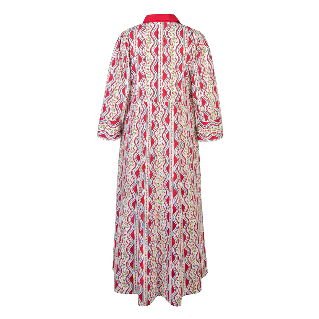 Long patterned dress with a red and white design on a white background