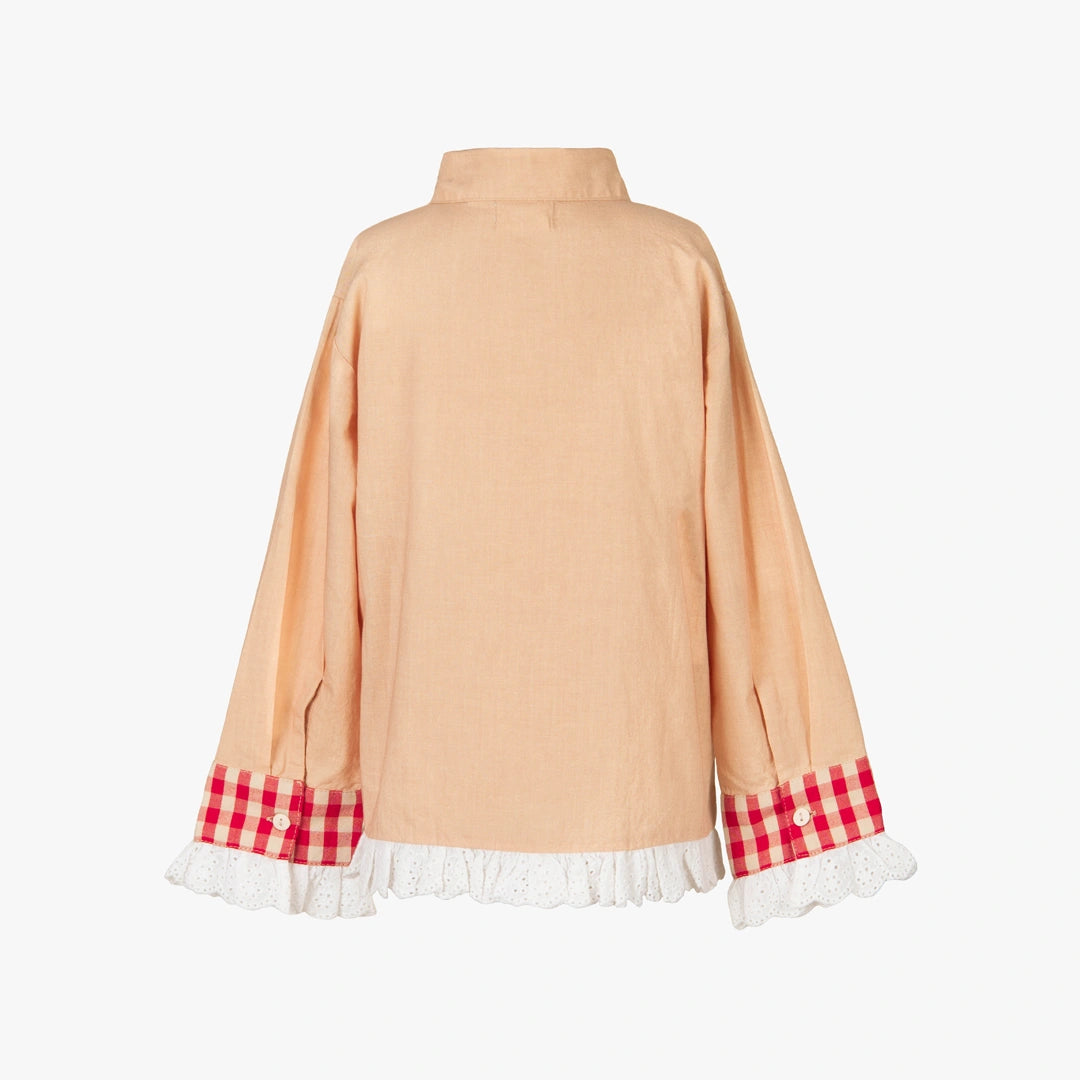 A peach-colored long-sleeve blouse shown from the back, featuring red and white gingham check cuffs with white lace ruffles at the hem.