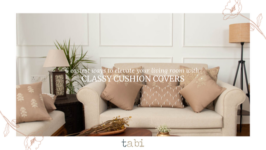 An elegant living room with a couch and decorative pillows, designed to create a warm and inviting ambiance.