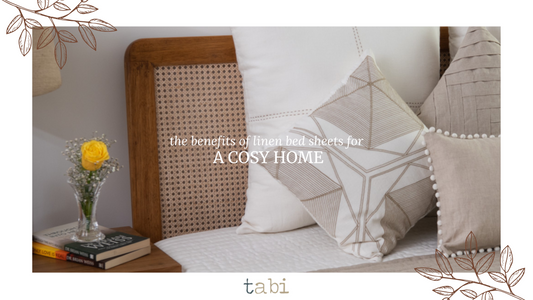 A cozy bed adorned with plush pillows and a vase of fresh flowers, showcasing the elegance of linen bed sheets.