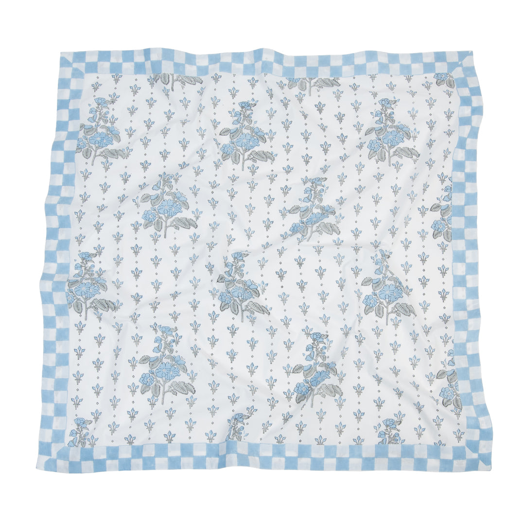 Floral patterned scarf with blue and white checkered border on a white background