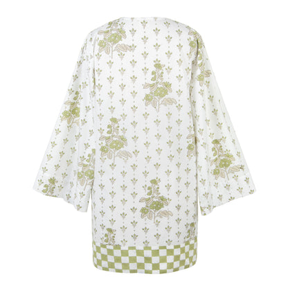 White garment with green floral pattern on a white background