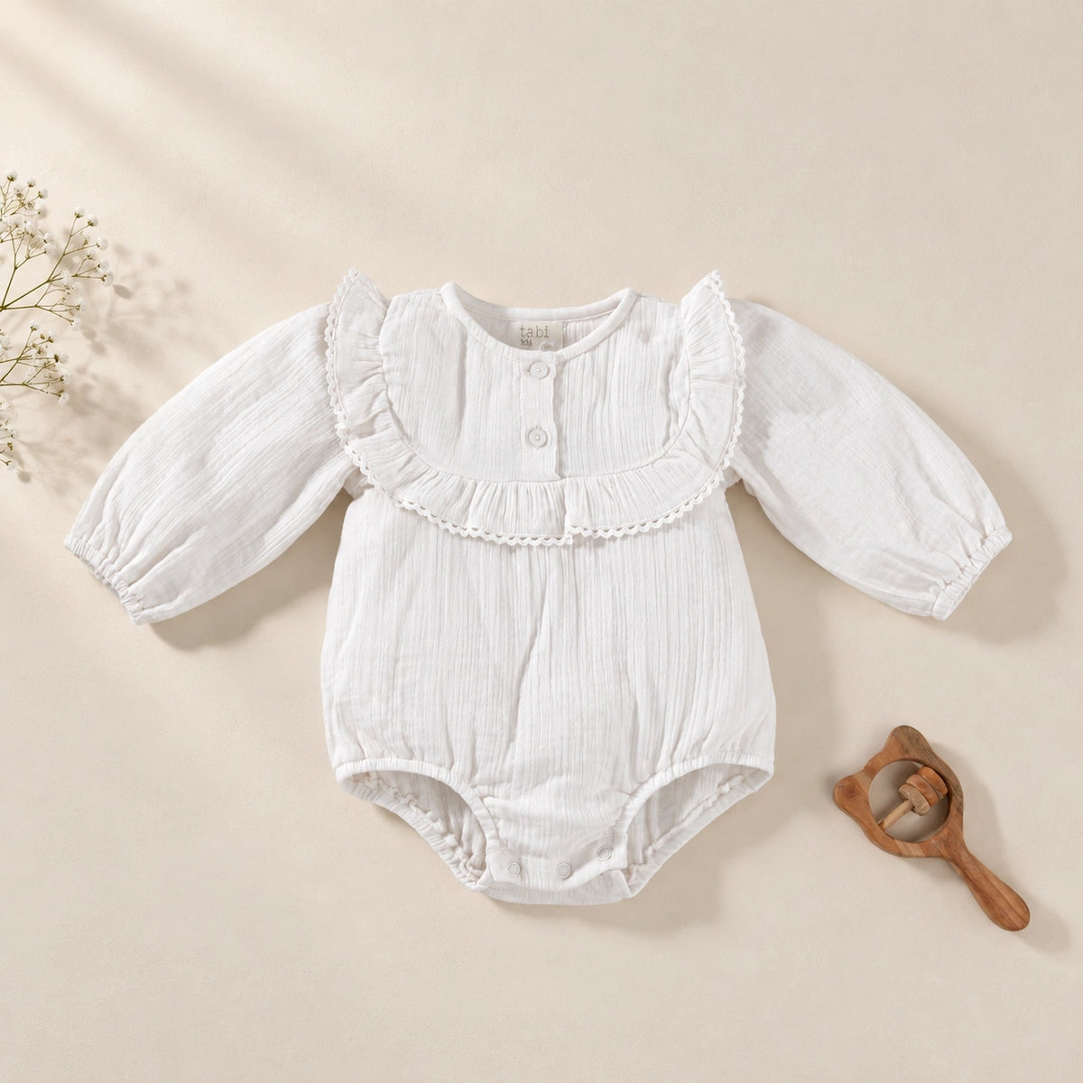 White  bodysuit with delicate lace detailing and full sleeves.