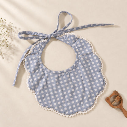A blue baby bib featuring delicate floral hand embroidery, adjustable tie-up closures and contrasting checked piping.
