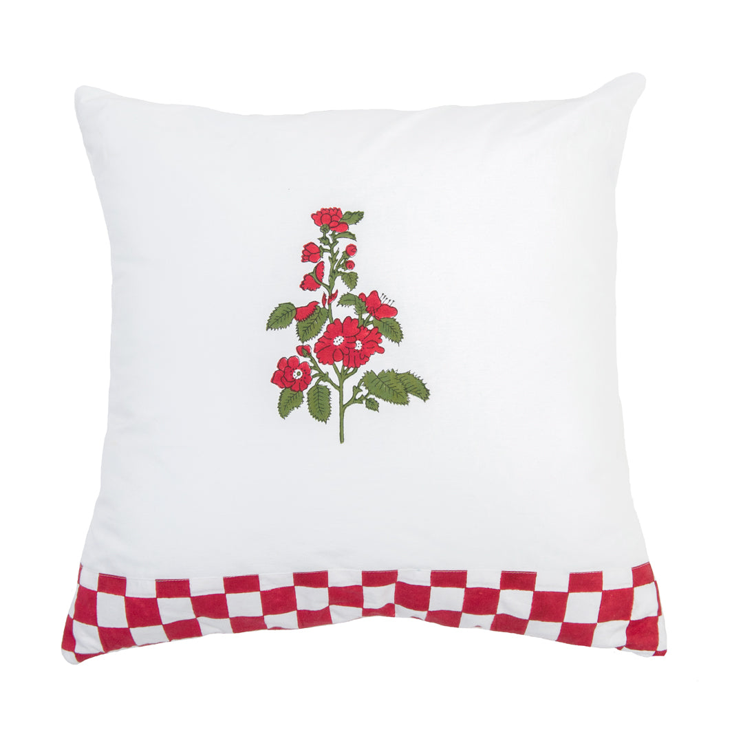 White pillow with red floral design and red and white checkered border on a white background