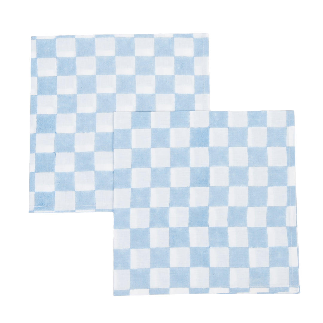 Two blue and white checkered placemats on a white background