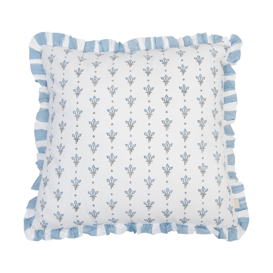 Decorative pillow with blue floral pattern and trim on a white background