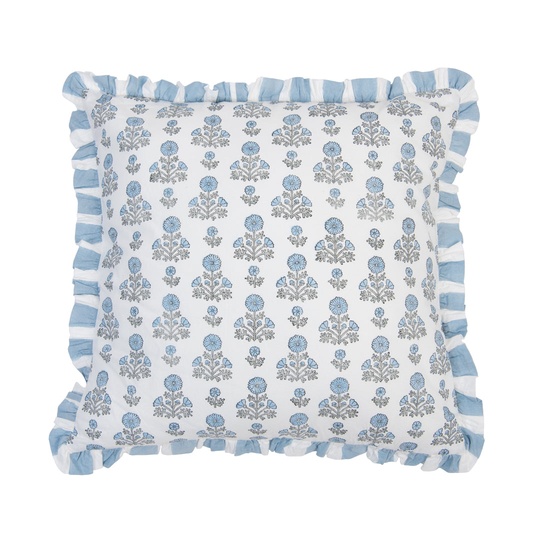 Decorative pillow with floral pattern and blue tassels on a white background