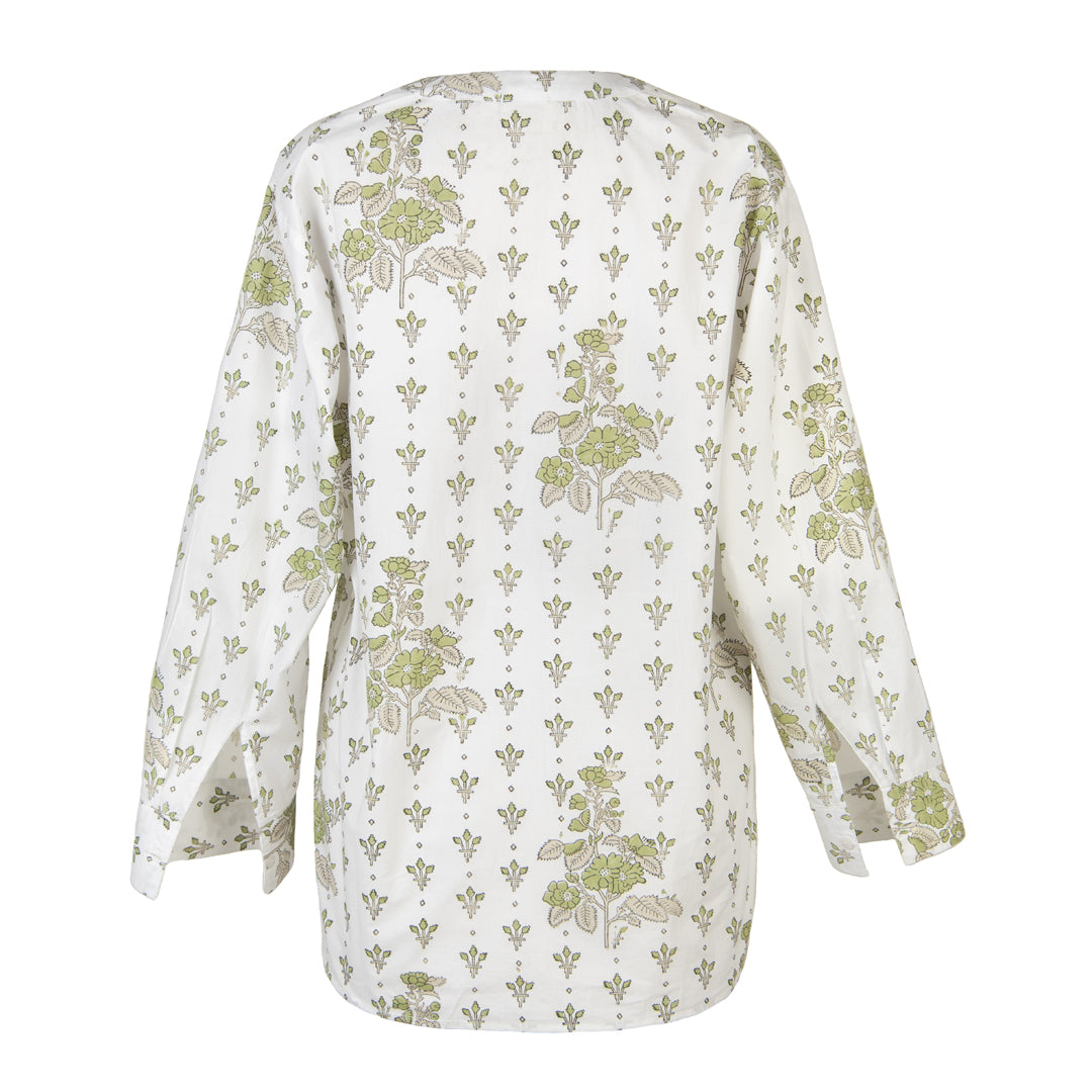 White blouse with green floral pattern on a white background