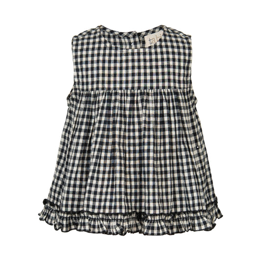Black and white checkered dress with ruffled hem on a white background
