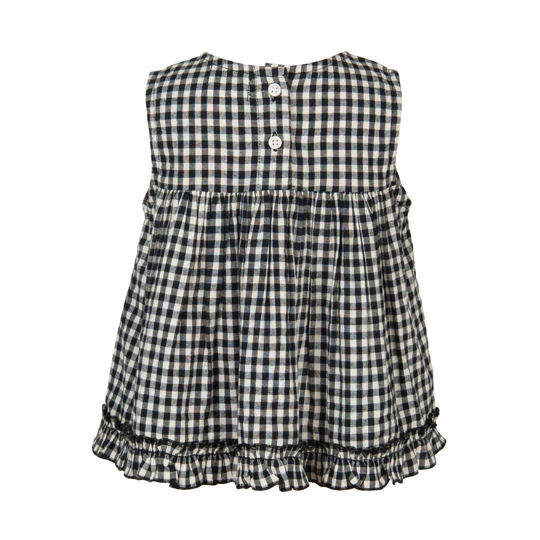 Black and white checkered dress with ruffled bottom on a white background