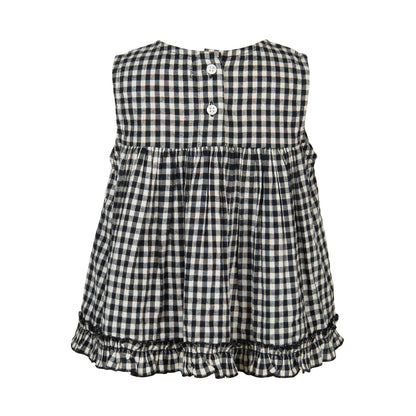 Black and white checkered dress with ruffled bottom on a white background