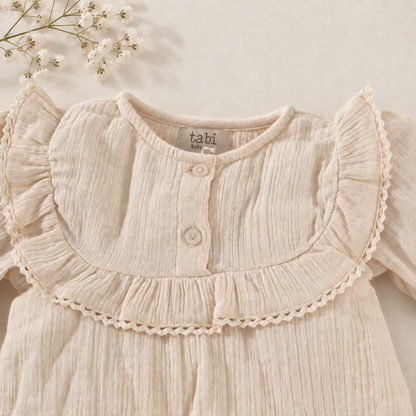 Beige bodysuit with delicate lace detailing and full sleeves.