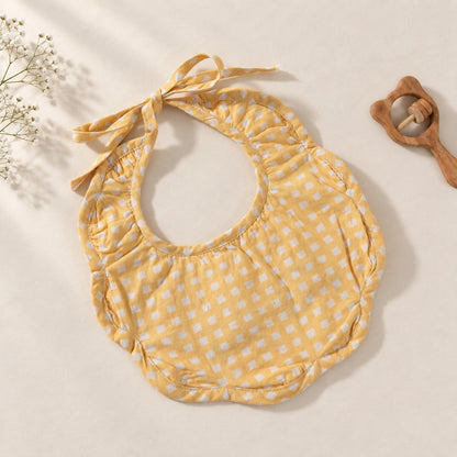 A yellow and white gingham patterned baby bib with a tie-neck design.