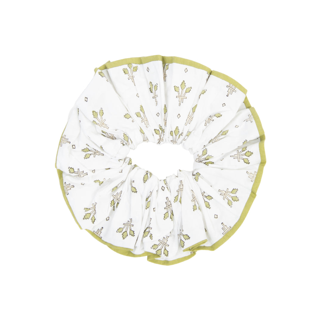 White pet bed with green floral pattern on a white background