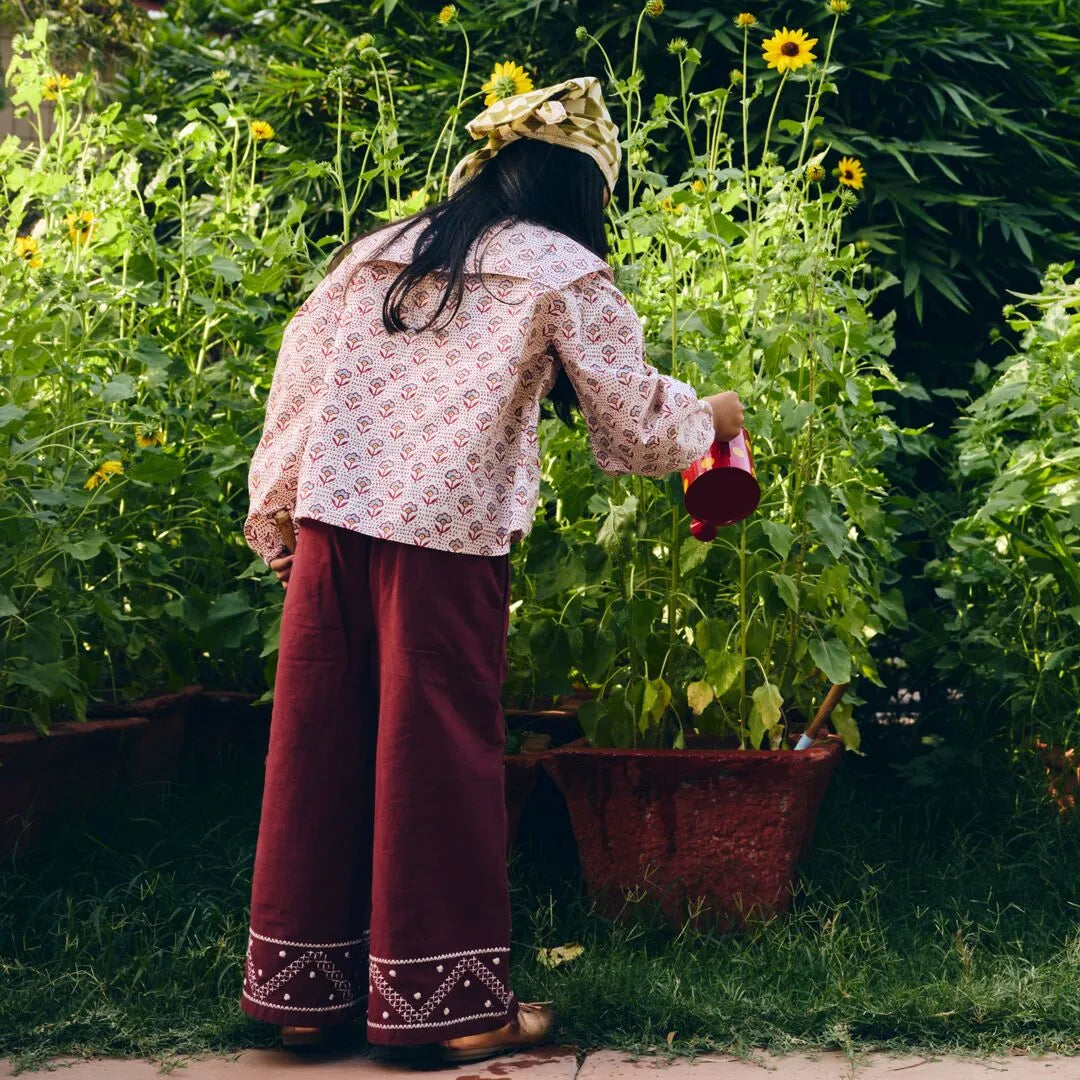 Person watering plants in a garden