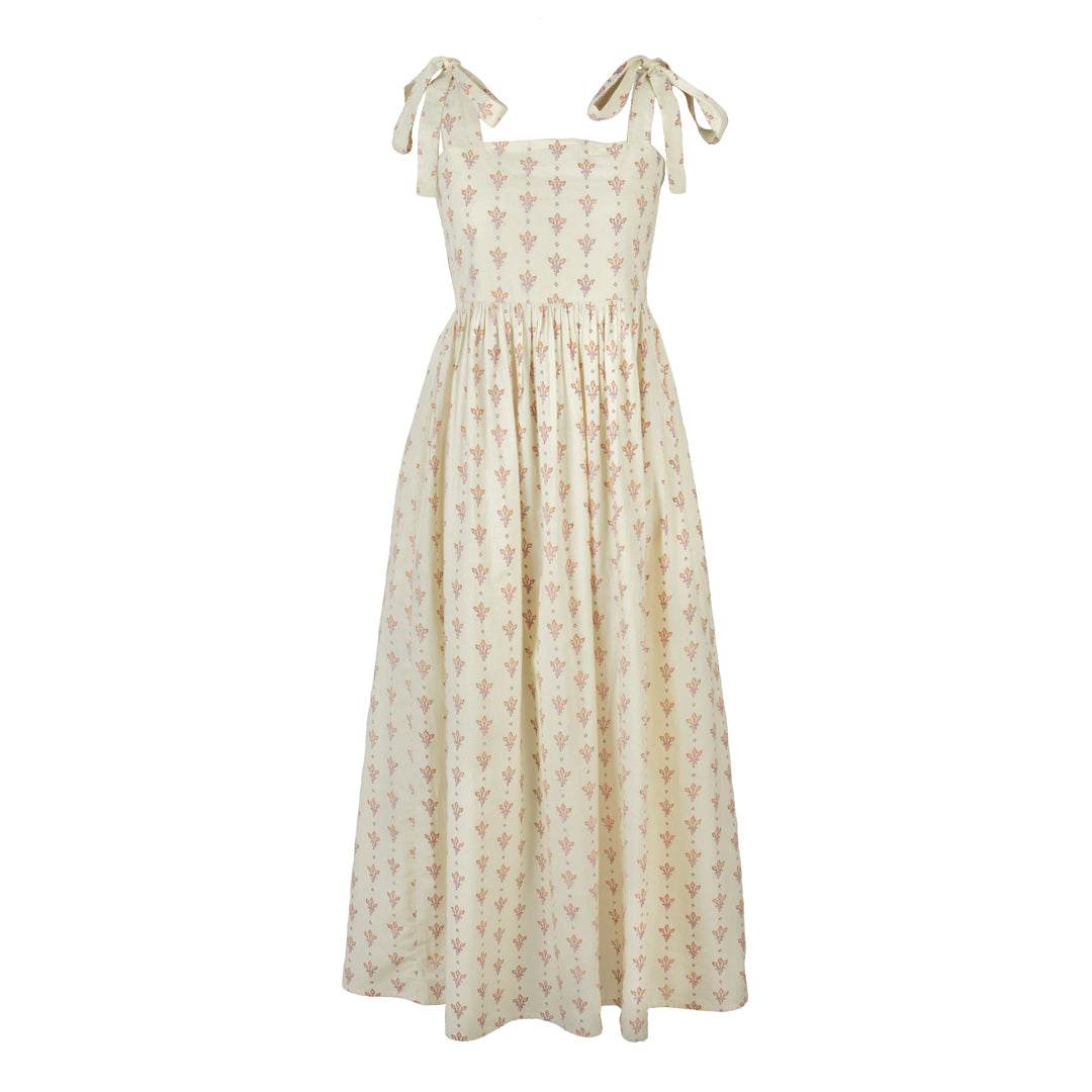 Beige floral dress with bow straps on a white background