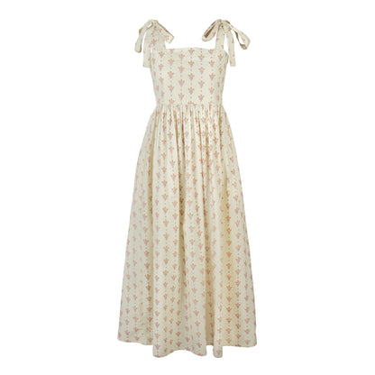 Beige floral dress with bow straps on a white background