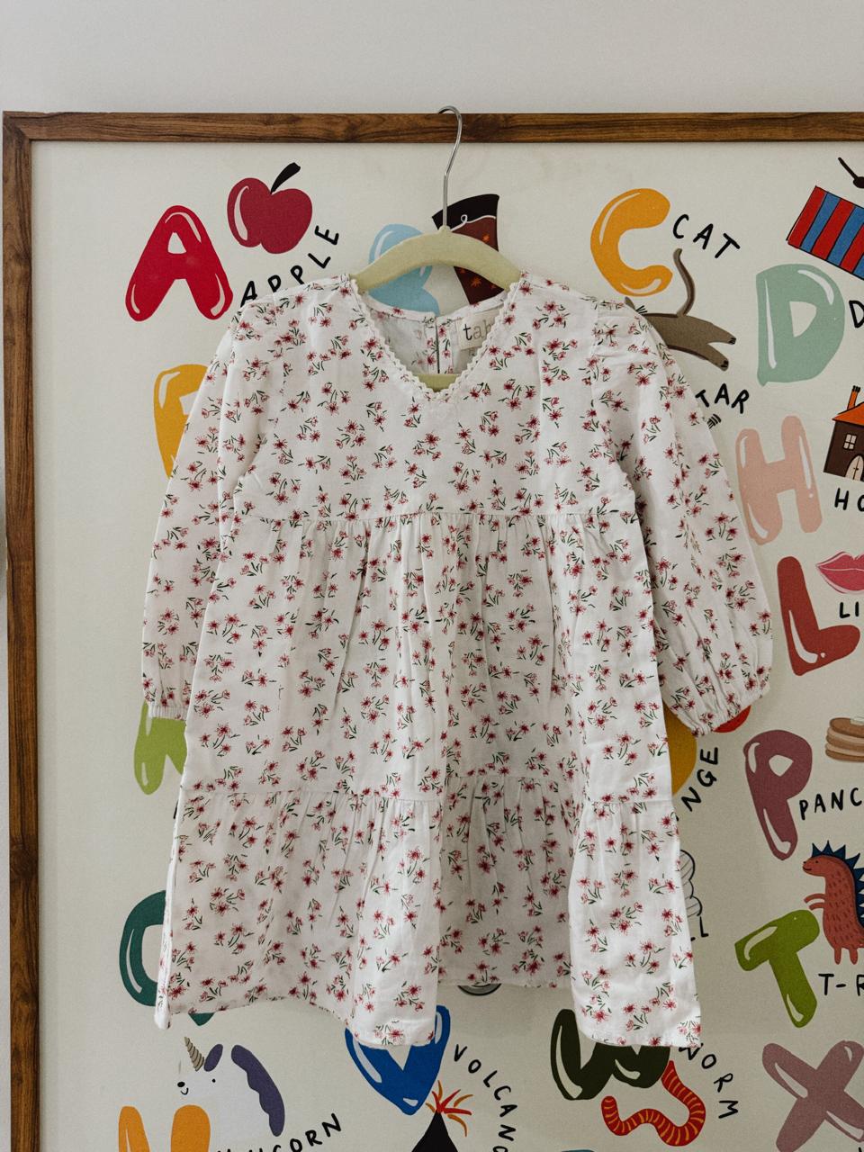 Floral dress hanging on a colorful children's art wall