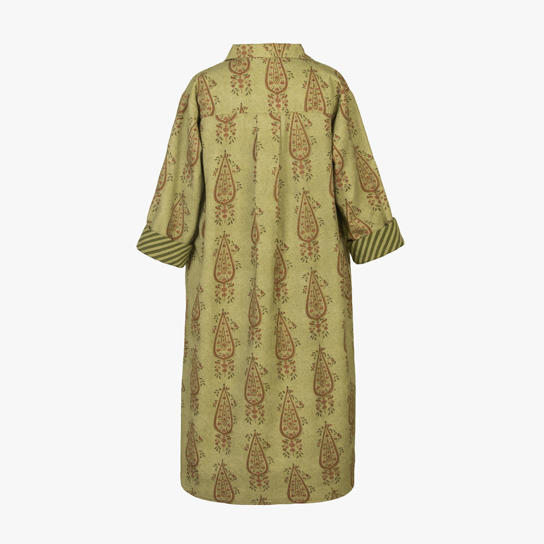 Green dress with brown pattern on a white background
