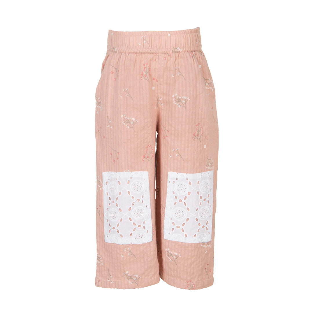 Pink pants with white lace panels on a white background