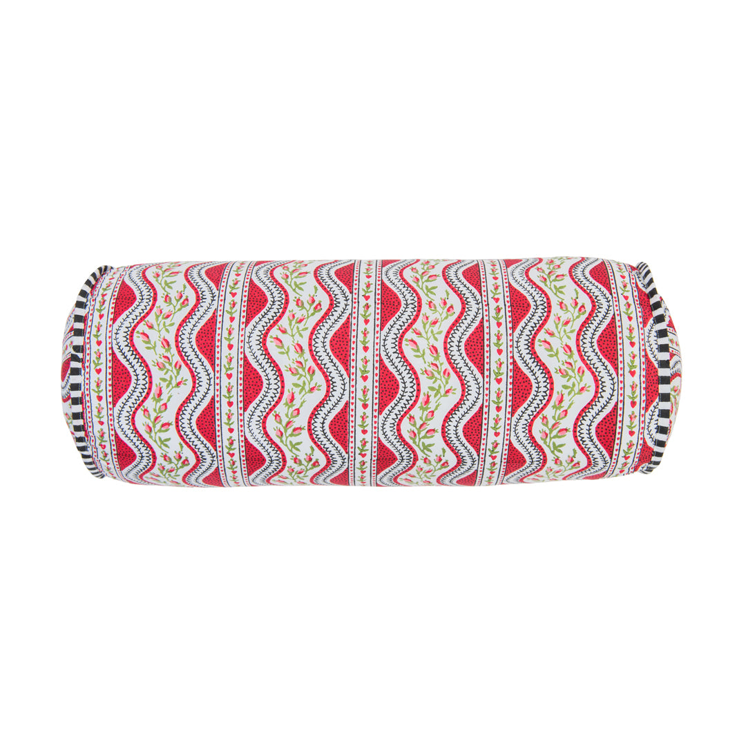 Decorative cylindrical pillow with red and white pattern on a white background