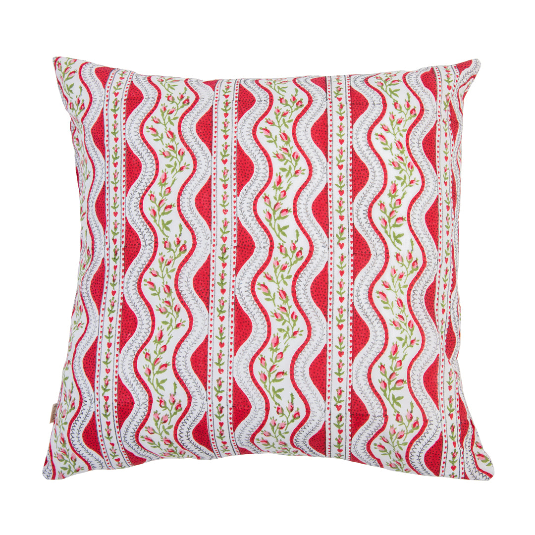 Decorative pillow with red, white, and green pattern on a white background