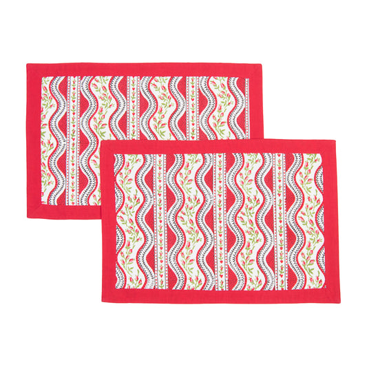 Two red placemats with white and green pattern on a white background