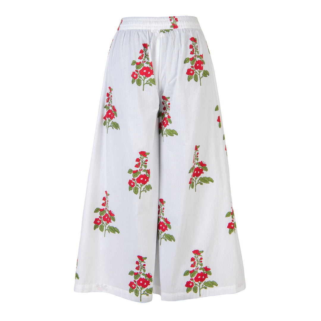 White pants with red floral patterns on a white background