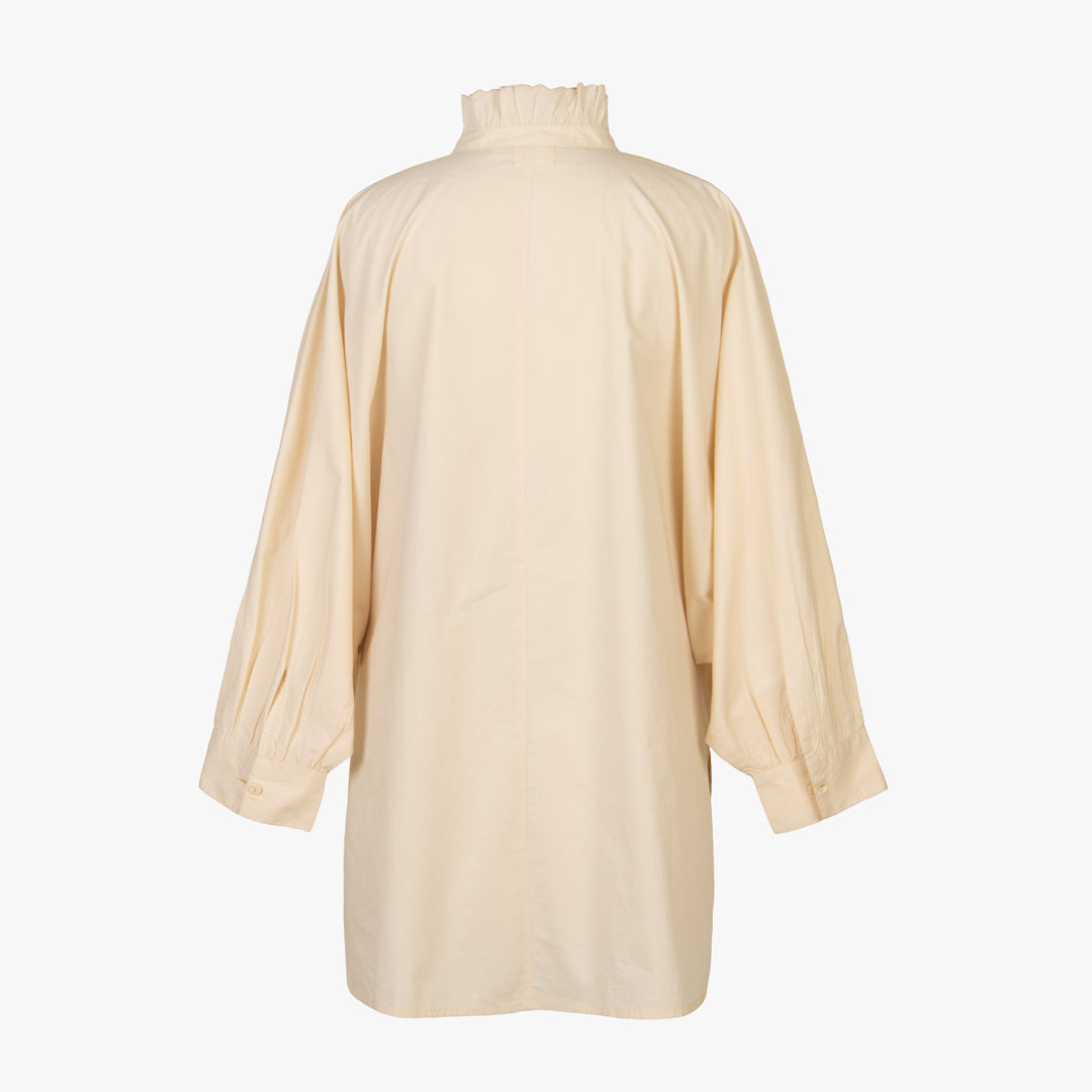 Beige long-sleeve top on a white background
