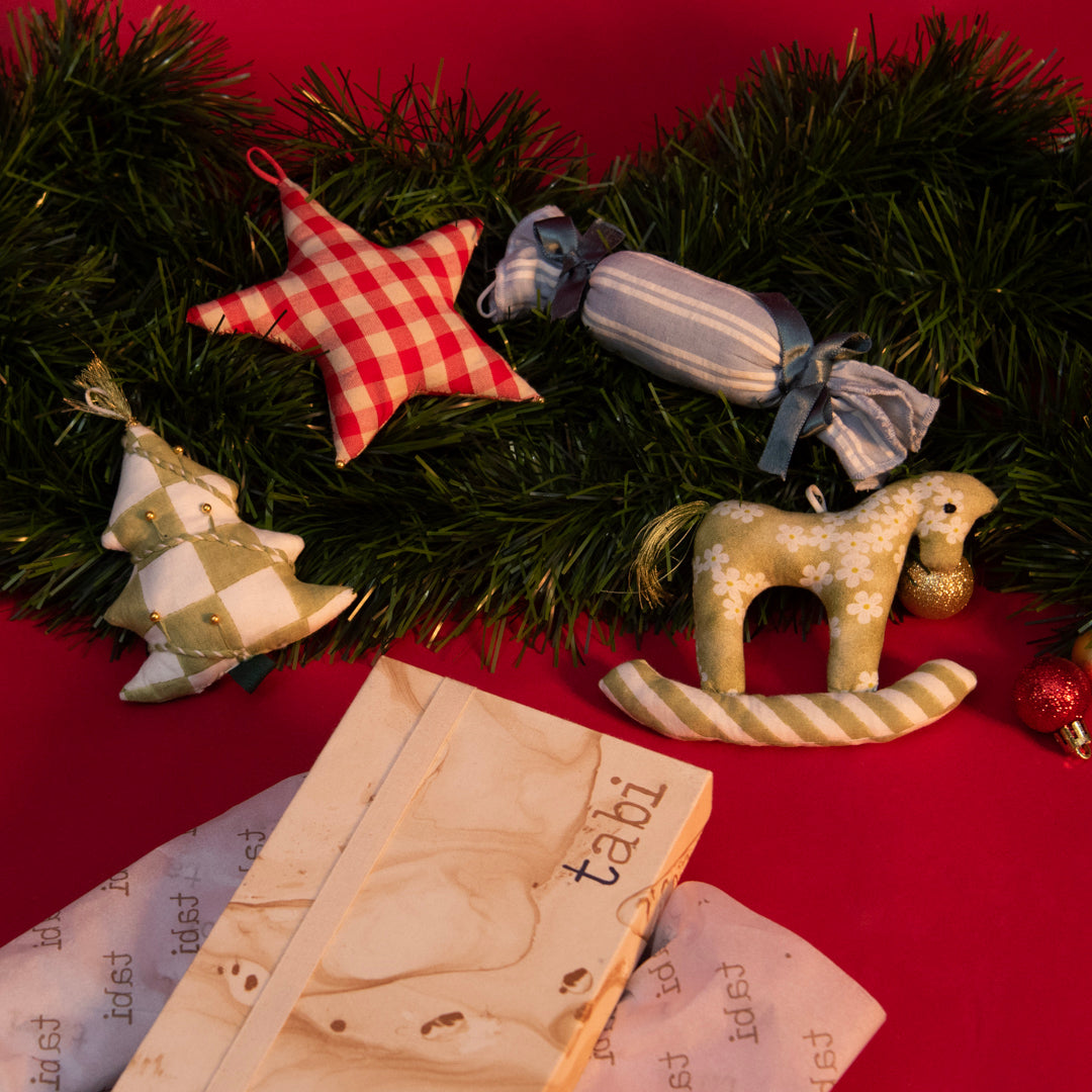 Decorative Christmas wreath with ornaments on a red background