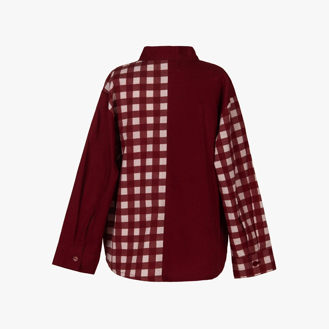 A long-sleeve button-up shirt shown from the back, featuring a solid deep burgundy body with a contrasting vertical gingham check pattern panel running down the center and across both sleeves.