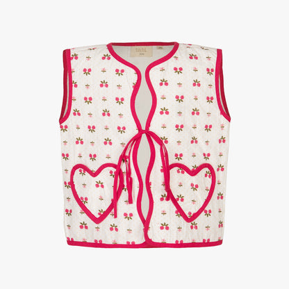 White tank top with pink heart designs and red trim on a white background