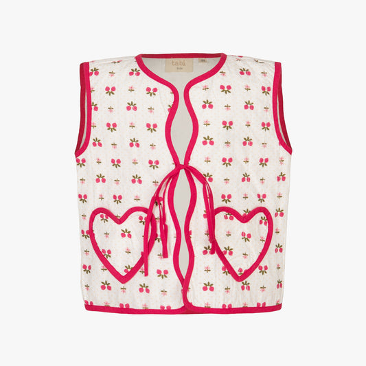 White tank top with pink heart designs and red trim on a white background