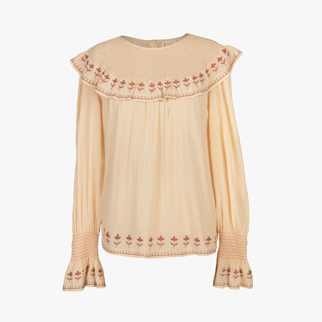 Beige blouse with floral embroidery on a white background