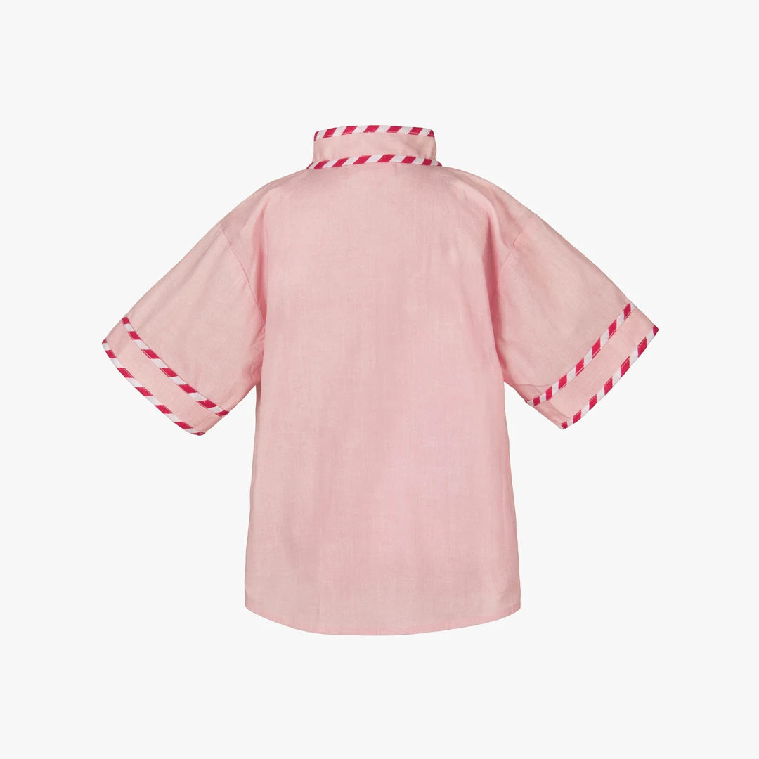 Pink kimono-style garment with red trim on a white background