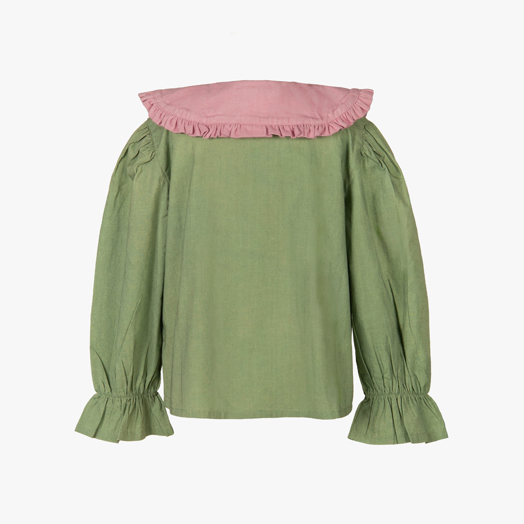Green top with pink neckline on a white background
