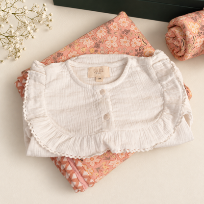 Beige bodysuit with delicate lace detailing and full sleeves.