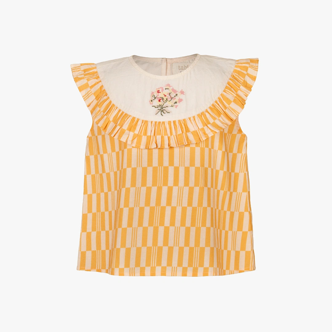 A sleeveless yellow and white checkered top with a cream-colored ruffled collar featuring a small pink floral embroidery, shown against a plain white background.