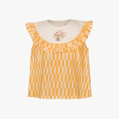 A sleeveless yellow and white checkered top with a cream-colored ruffled collar featuring a small pink floral embroidery, shown against a plain white background.