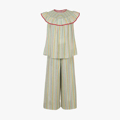 A two-piece children's outfit featuring a sleeveless top with a wide pleated ruffle collar and matching wide-leg pants, both in a light sage green fabric with vertical pastel stripes of yellow, blue, and orange, finished with a red inner collar trim.