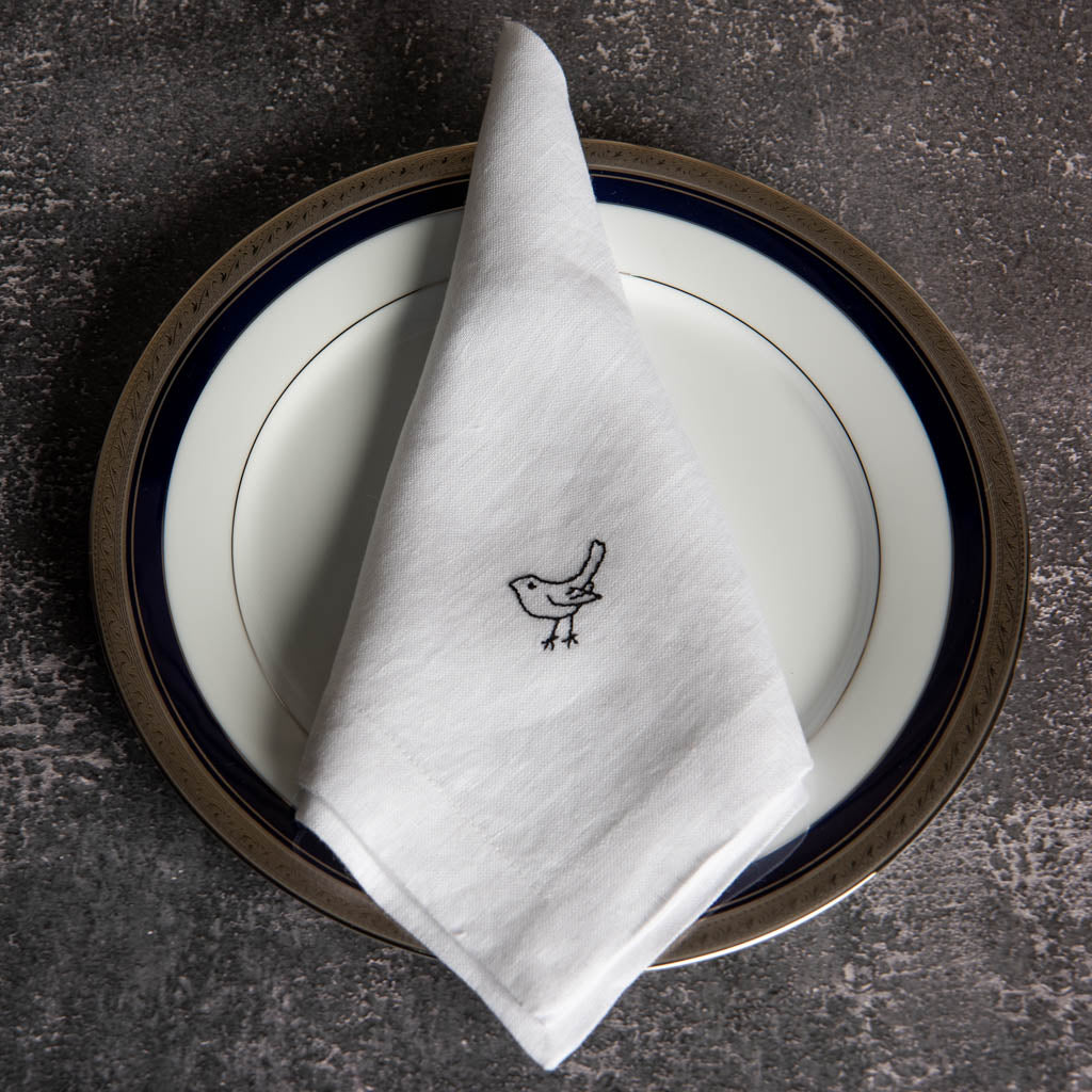 Embroidered white linen dinner napkins