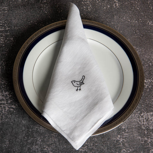 Embroidered white linen dinner napkins